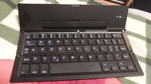 Ultra-Thin Folding Bluetooth Keyboard with Phone Holder Support photo review