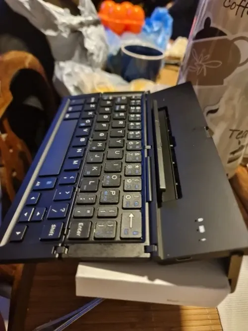 Ultra-Thin Folding Bluetooth Keyboard with Phone Holder Support photo review